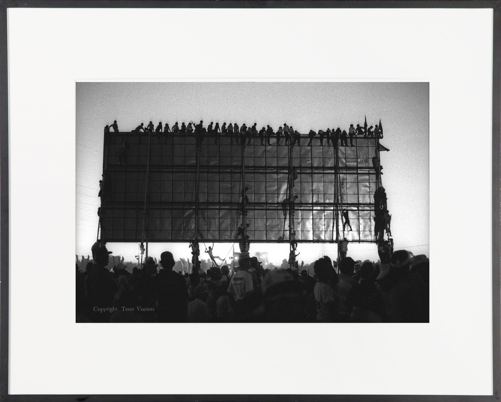 People scale election billboard