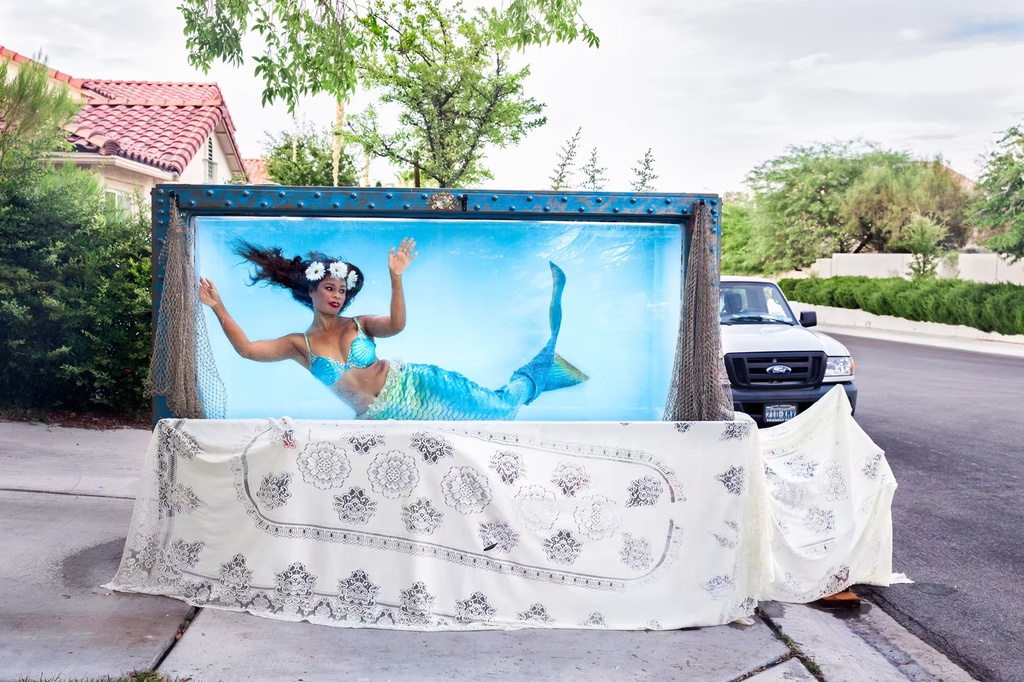 Mermaid Farasha in a tank on her driveway (NV, USA), 2019
